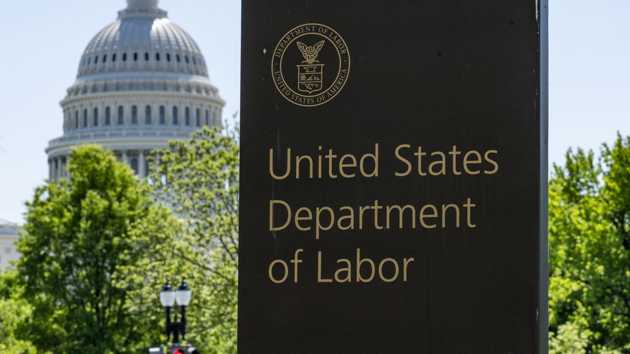 FILE - In this May 7, 2020, file photo, the entrance to the Labor Department is seen near the Capitol in Washington. (AP Photo/J. Scott Applewhite, File)