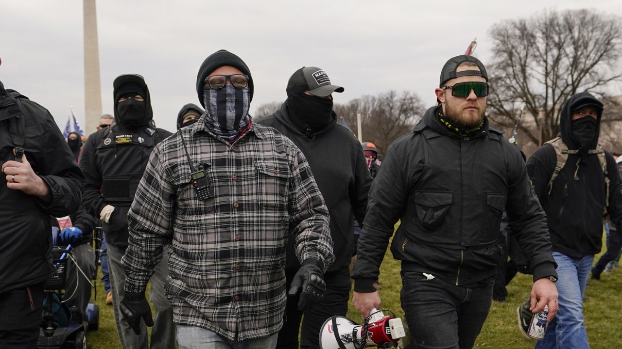In this Jan. 6, 2021, photo, Proud Boy members Joseph Biggs, left, and Ethan Nordean, right with megaphone, walk toward the U.S. Capitol in Washington on Jan. 6. (AP Photo/Carolyn Kaster)