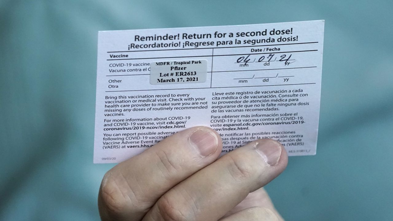 FILE: A second shot reminder card for Pfizer's COVID-19 vaccine is seen Wednesday, March 17, 2021, at the Miami-Dade County Tropical Park vaccination site in Miami. (AP Photo/Wilfredo Lee)
