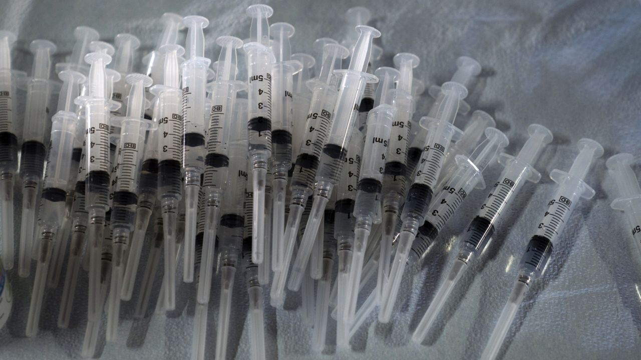 FILE - In this March 5, 2021, file photo, syringes prepared with Pfizer's COVID-19 vaccine sit at a vaccination site in Long Beach, Calif. (AP Photo/Jae C. Hong, File)