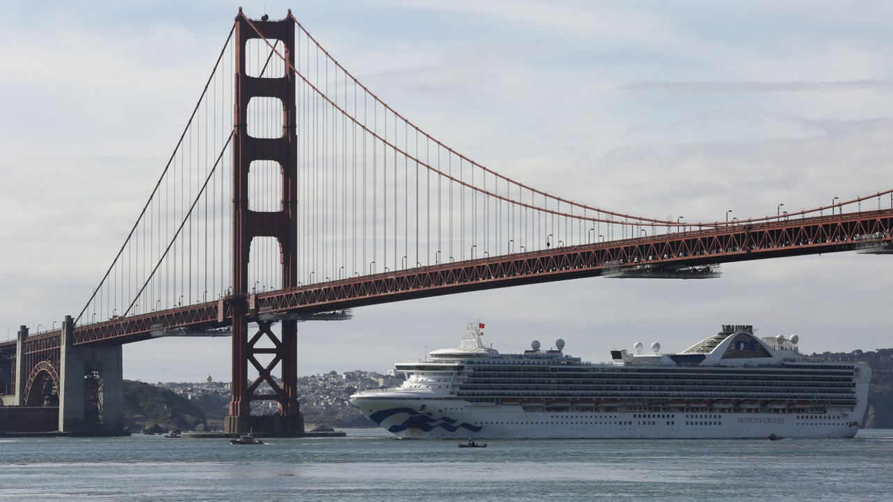 FILE - In this March 9, 2020, file photo, the Grand Princess cruise ship passes beneath the Golden Gate Bridge in this view from Sausalito, Calif. (AP Photo/Eric Risberg)