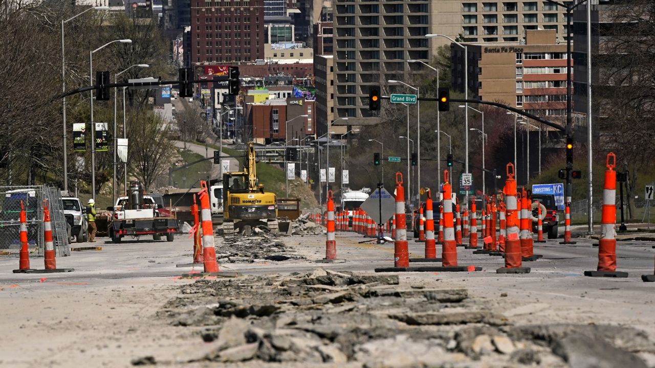 FILE - In this Wednesday, March 30, 2021 file photo, workers replace old water lines under Main Street in Kansas City, Mo. (AP Photo/Charlie Riedel)
