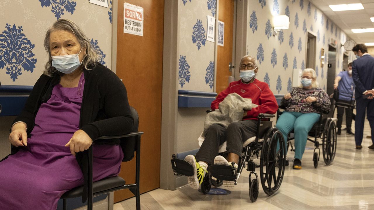 FILE - In this Friday, Jan. 15, 2021 file photo, nursing home residents wait on line to receive a COVID-19 vaccine at Harlem Center for Nursing and Rehabilitation. (AP Photo/Yuki Iwamura, File)