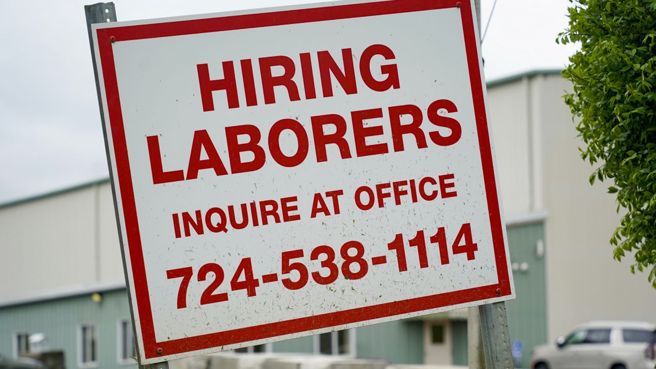 FILE: A sign seeking to hire laborers is posted outside a concrete products company in Evans City, Pa., Wednesday, May 5, 2021. (AP Photo/Keith Srakocic)