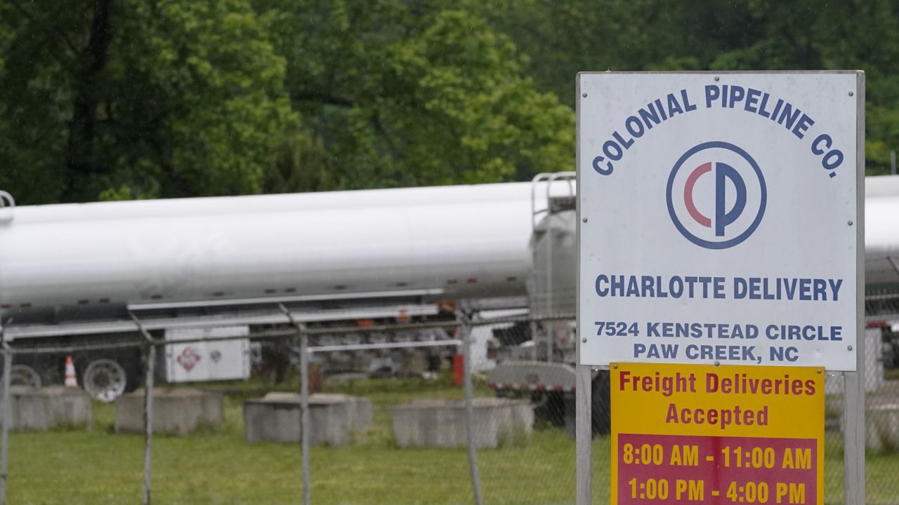 Tanker trucks are parked near the entrance of Colonial Pipeline Company Wednesday, May 12, 2021, in Charlotte, N.C. (AP Photo/Chris Carlson)