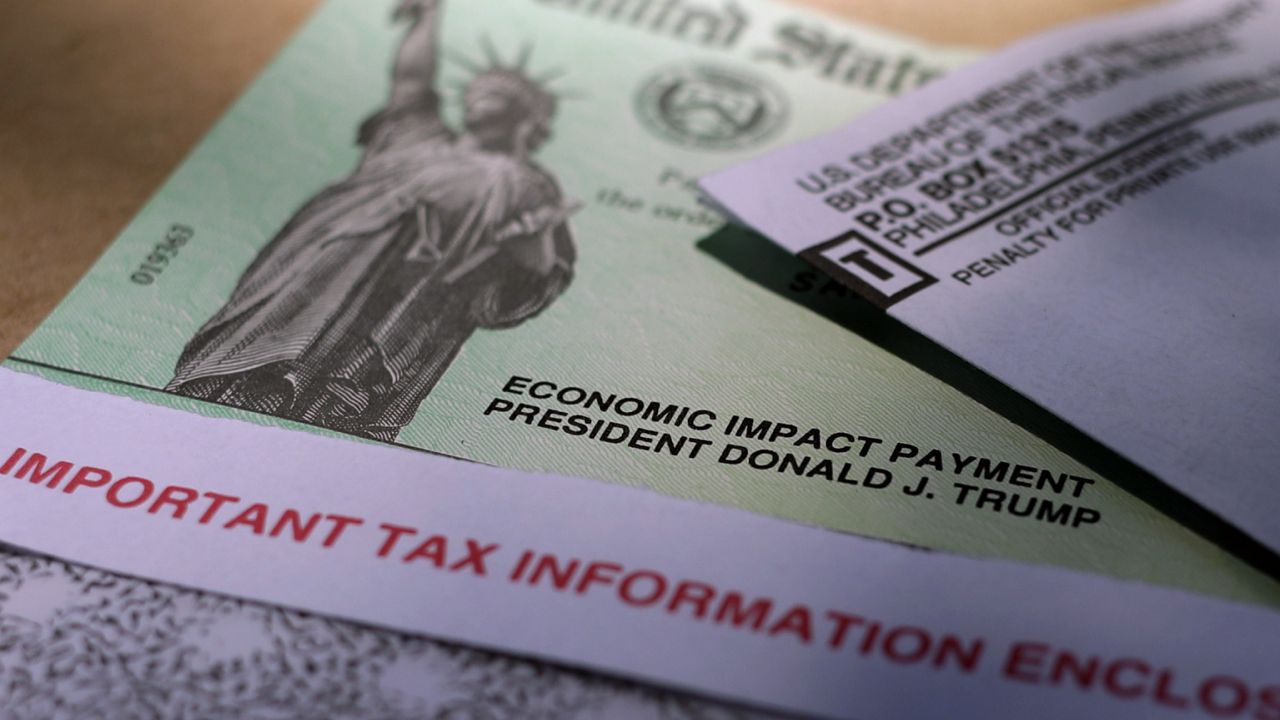 FILE - Donald J. Trump's name is printed on a stimulus check issued by the IRS to help combat the adverse economic effects of the COVID-19 outbreak. (AP Photo/Eric Gay, File)