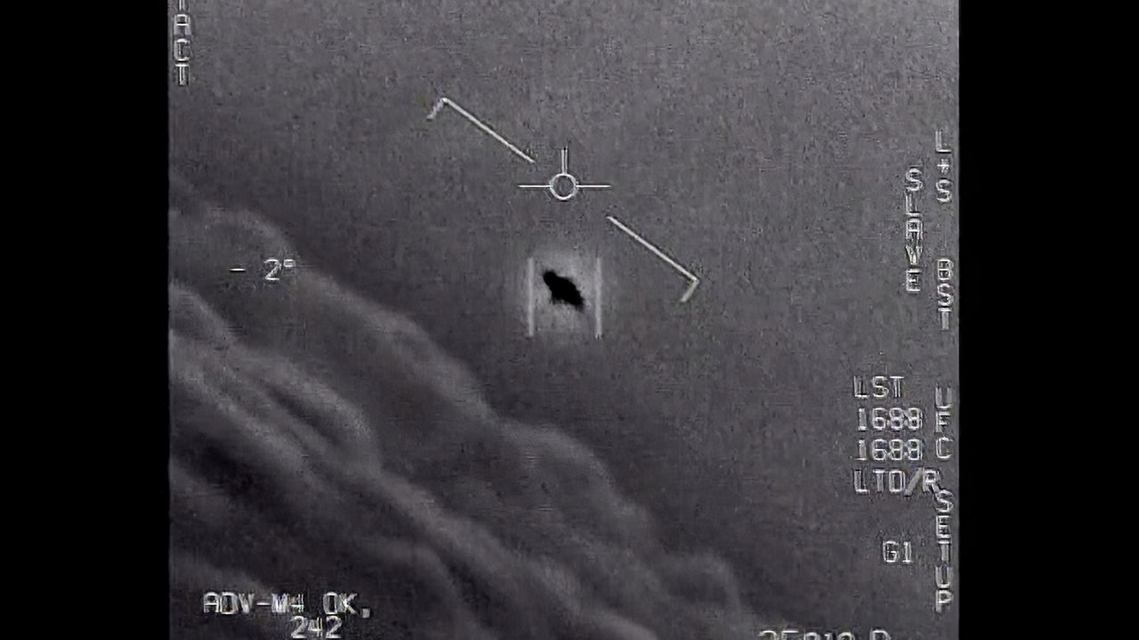 The image from video provided by the Department of Defense labelled Gimbal, from 2015, an unexplained object is seen at center as it is tracked as it soars high along the clouds. (Department of Defense via AP)