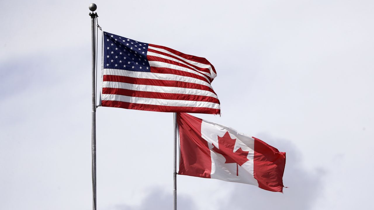 FILE: U.S. and Canadian flags fly atop the Peace Arch at Peace Arch Historical State Park. (AP Photo/Elaine Thompson)