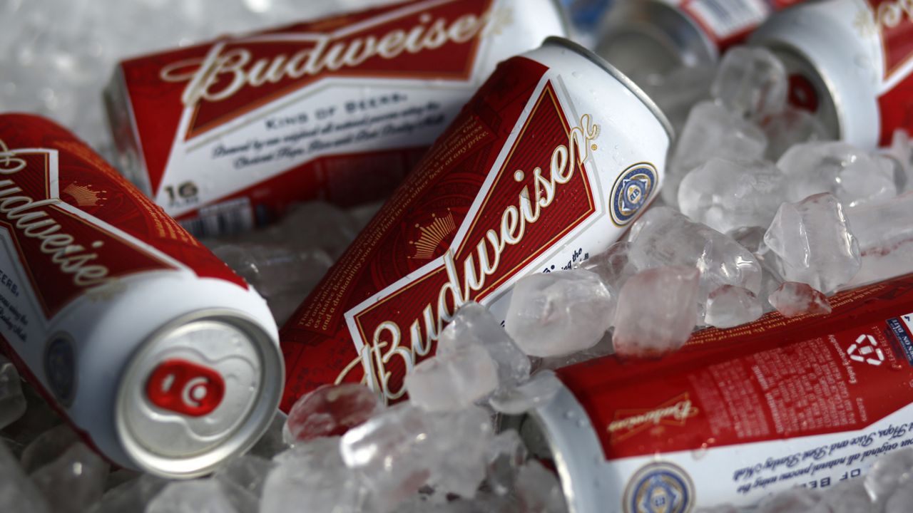 FILE - In this Thursday, March 5, 2015, file photo, Budweiser beer cans are on ice at a concession stand. (AP Photo/Gene J. Puskar, File)