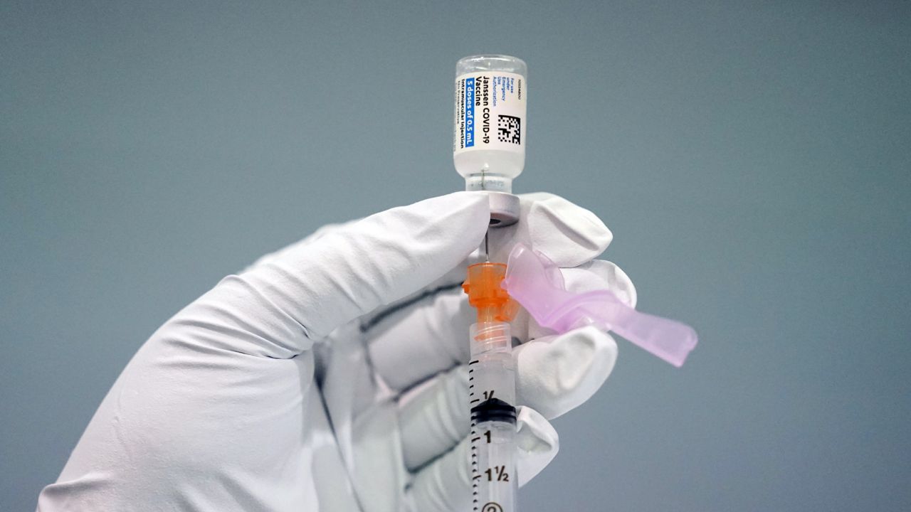 FILE - In this March 26, 2021, file photo a member of the Philadelphia Fire Department prepares a dose of the Johnson & Johnson COVID-19 vaccine. (AP Photo/Matt Rourke, File)