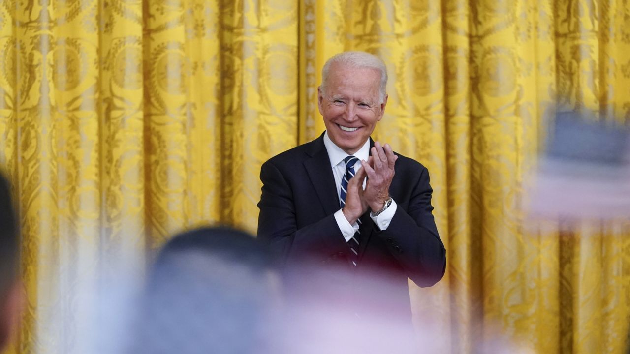 President Joe Biden applauds after people took the Oath of Allegiance during a naturalization ceremony in the East Room of the White House, Friday, July 2, 2021, in Washington. (AP Photo/Patrick Semansky)