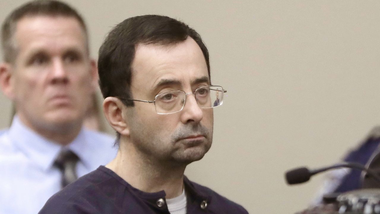 FILE - In this Jan. 24, 2018, file photo, Larry Nassar, a former doctor for USA Gymnastics and member of Michigan State's sports medicine staff, sits in court during his sentencing hearing in Lansing, Mich. (AP Photo/Carlos Osorio, File)