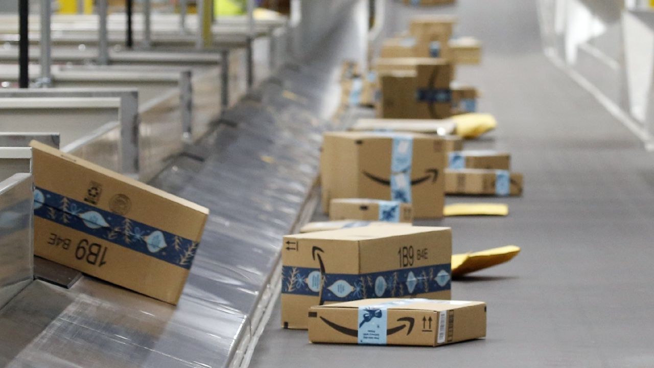 FILE - Amazon packages move along a conveyor at an Amazon warehouse facility in Goodyear, Ariz. (AP Photo/Ross D. Franklin, File)