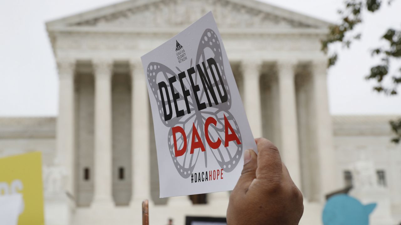 tFILE - In this Nov. 12, 2019, file photo people rally outside the Supreme Court over President Trump's decision to end the Deferred Action for Childhood Arrivals program (DACA). (AP Photo/Jacquelyn Martin, File)