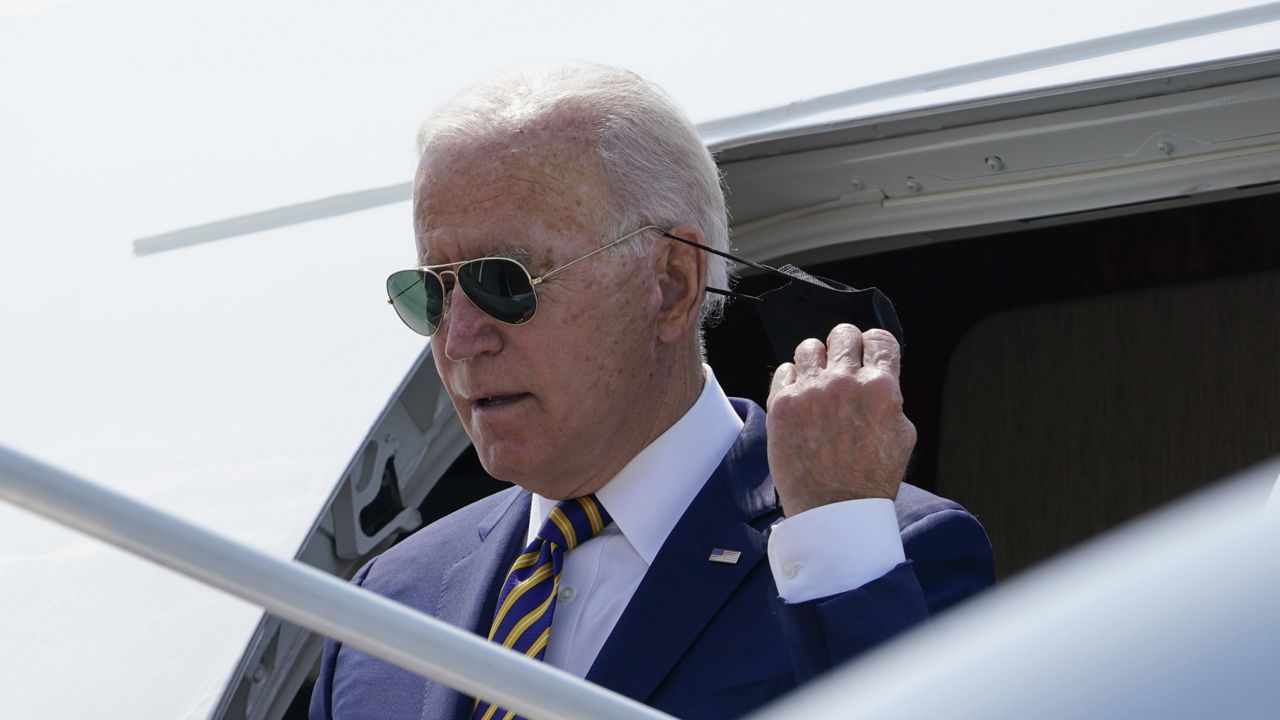 FILE: President Joe Biden takes off his mask as he walks off of Air Force One at Lehigh Valley International Airport in Allentown, Pa., Wednesday, July 28, 2021. (AP Photo/Susan Walsh)