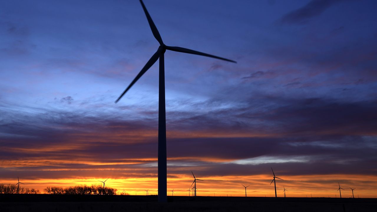 FILE - On Jan. 13, 2021, wind turbines are silhouetted against the sky at dawn near Spearville, Kan. (AP Photo/Charlie Riedel, File)