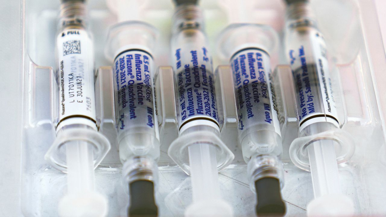 FILE - This Saturday, Oct. 17, 2020 file photo shows influenza vaccine syringes at the L.A. Care Health Plan and Blue Shield of California. (AP Photo/Damian Dovarganes)
