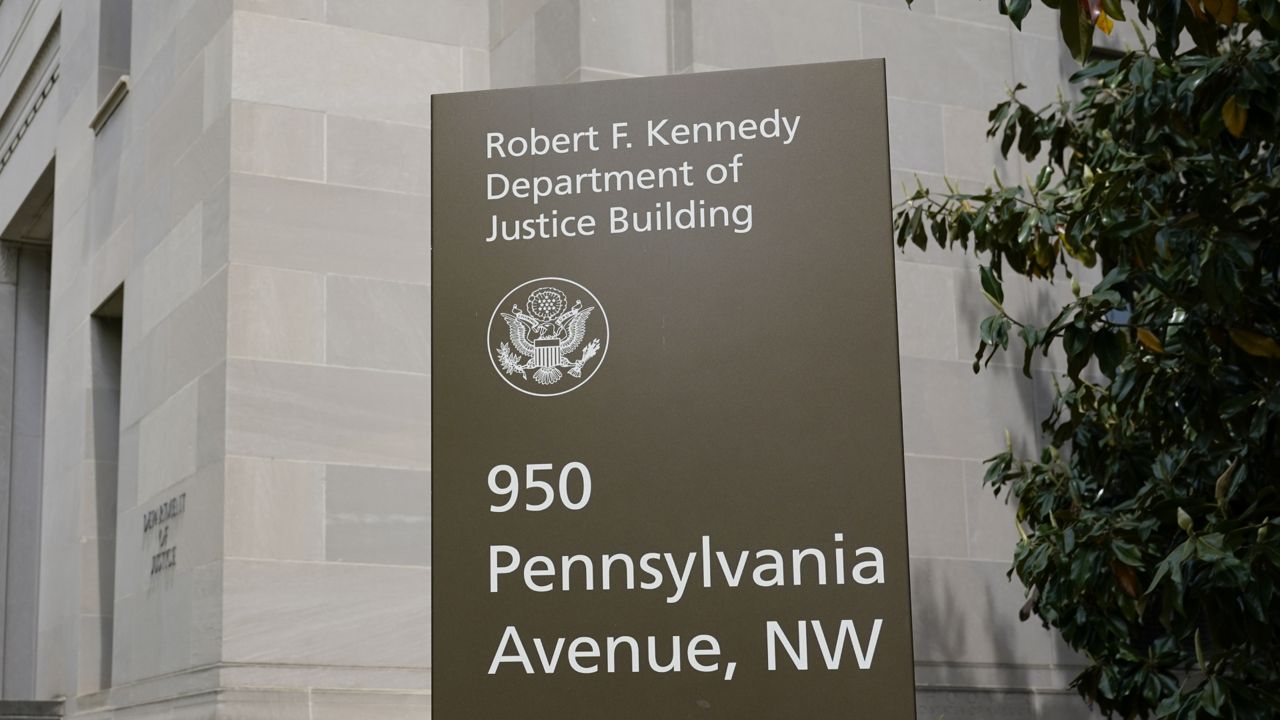 FILE - This May 4, 2021 file photo shows a sign outside the Robert F. Kennedy Department of Justice building in Washington. (AP Photo/Patrick Semansky, File)