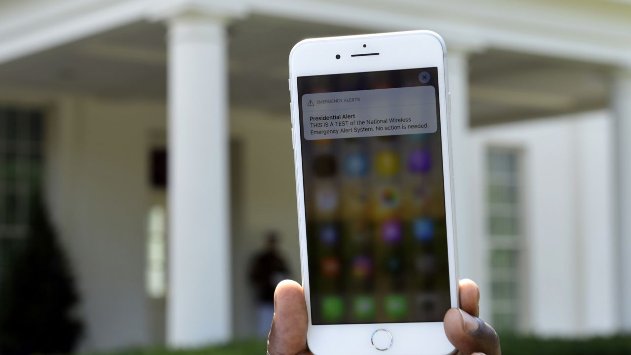 FILE: The first test of the national wireless emergency system by the Federal Emergency Management Agency is shown on a cellular phone at the White House in Washington, Wednesday, Oct. 3, 2018. (AP Photo/Susan Walsh)