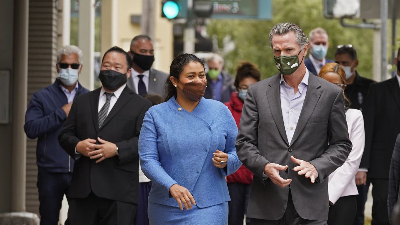 California Gov. Gavin Newsom walks with San Francisco Mayor London Breed on Geary Street on June 3, 2021. (AP Photo/Eric Risberg)