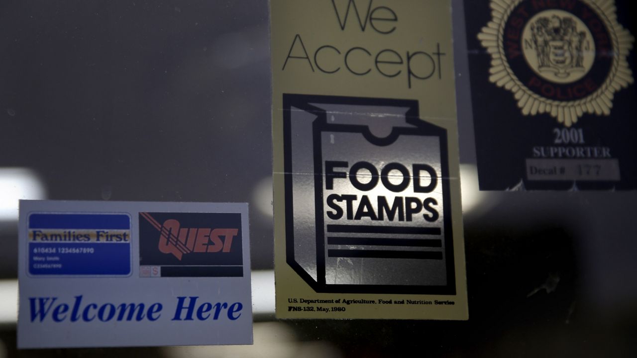 FILE - In this Jan. 12, 2015 file photo, a supermarket displays stickers indicating they accept food stamps in West New York, N.J. (AP Photo/Seth Wenig, File)