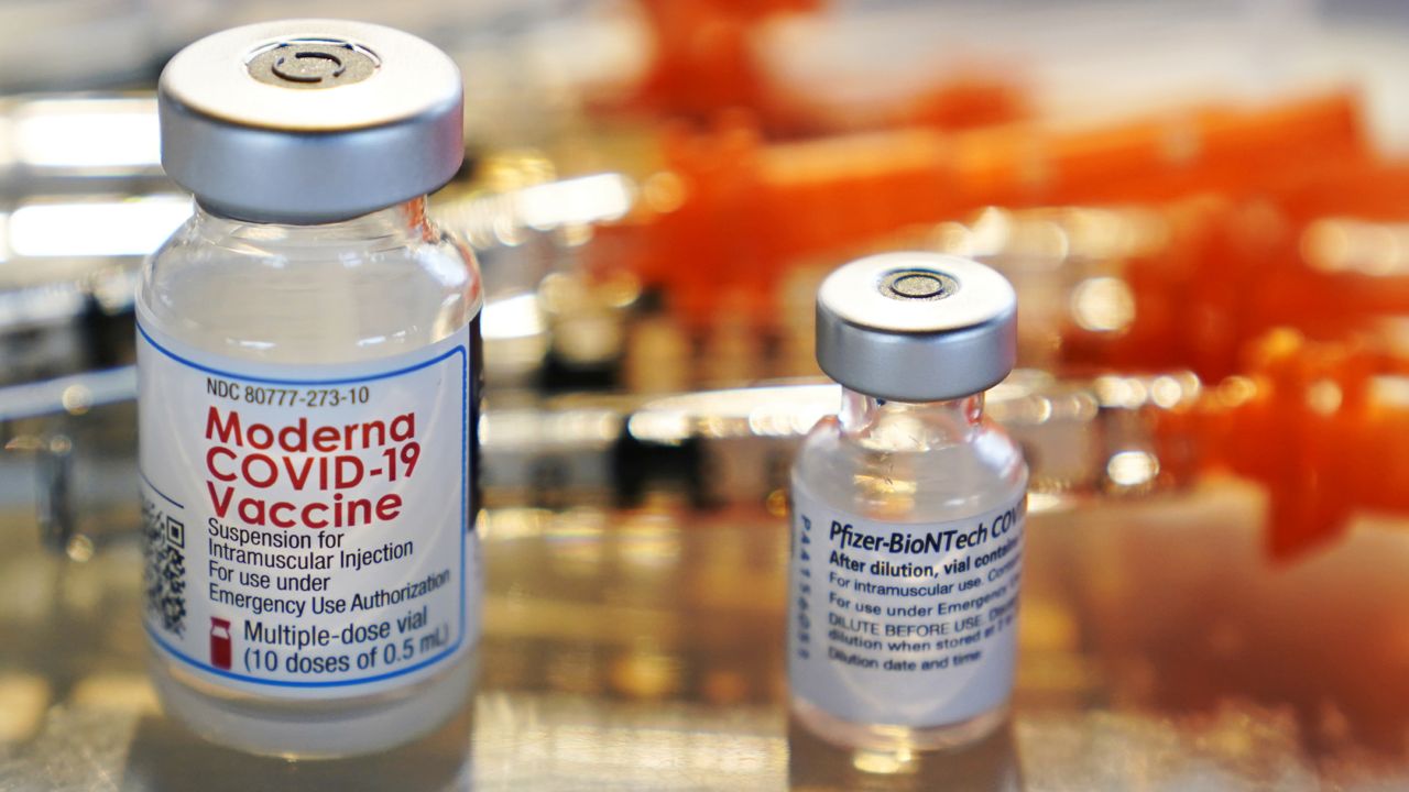 FILE - In this Thursday, Feb. 25, 2021 file photo, vials for the Moderna and Pfizer COVID-19 vaccines are displayed on a tray in Exeter, N.H. (AP Photo/Charles Krupa)