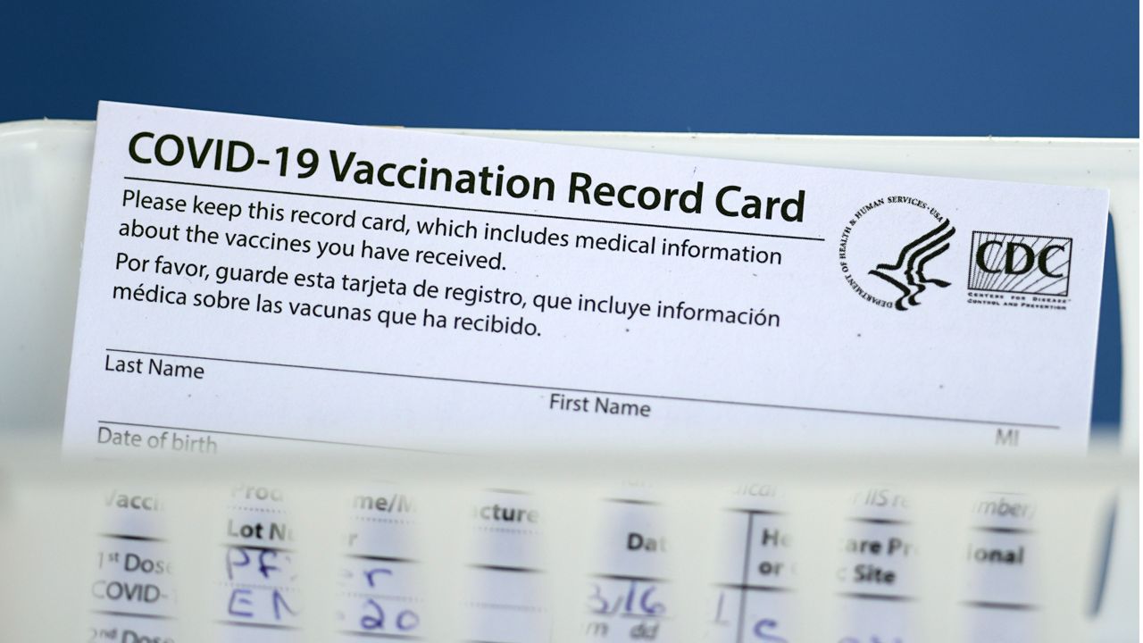FILE: A vaccination record card is shown during a COVID-19 vaccination drive on Tuesday, March 16, 2021, in Houston. (AP Photo/David J. Phillip)
