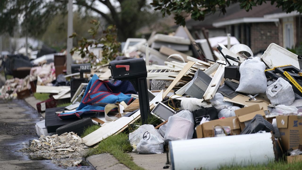 Piles of debris sit curbside as people gut their flooded homes in the aftermath of Hurricane Ida in LaPlace, La., Tuesday, Sept. 7, 2021. (AP Photo/Gerald Herbert)