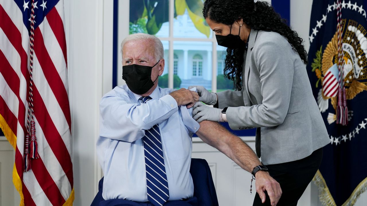 President Joe Biden receives a COVID-19 booster shot during an event in the South Court Auditorium on the White House campus, Monday, Sept. 27, 2021, in Washington. (AP Photo/Evan Vucci)