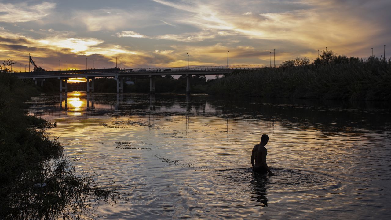 A Haitian migrant bathes in the waters of the Rio Grande in Ciudad Acuna, Mexico, Friday, Sept. 24, 2021, across from Del Rio, Texas. (AP Photo/Felix Marquez)