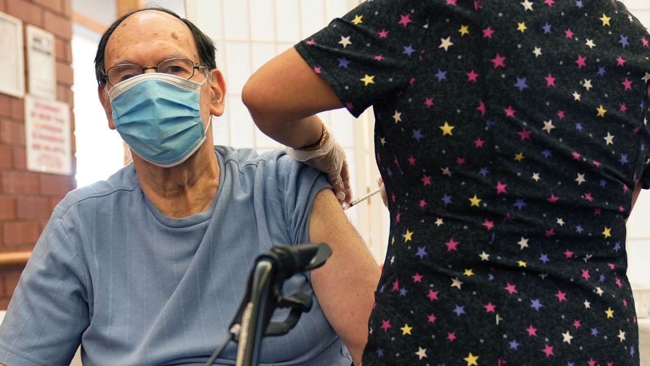 Marvin Marcus, 79, a resident at the Hebrew Home at Riverdale, receives a COVID-19 booster shot in New York, Monday, Sept. 27, 2021. (AP Photo/Seth Wenig)