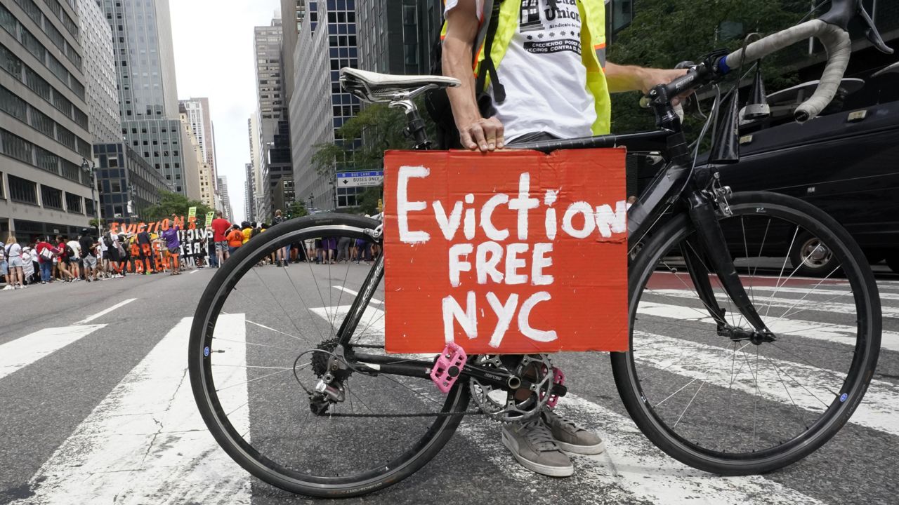 FILE: An activist uses his bike to block traffic as other demonstrate in front of New York Gov. Kathy Hochul's office during a rally, Tuesday, Aug. 31, 2021. (AP Photo/Mary Altaffer)