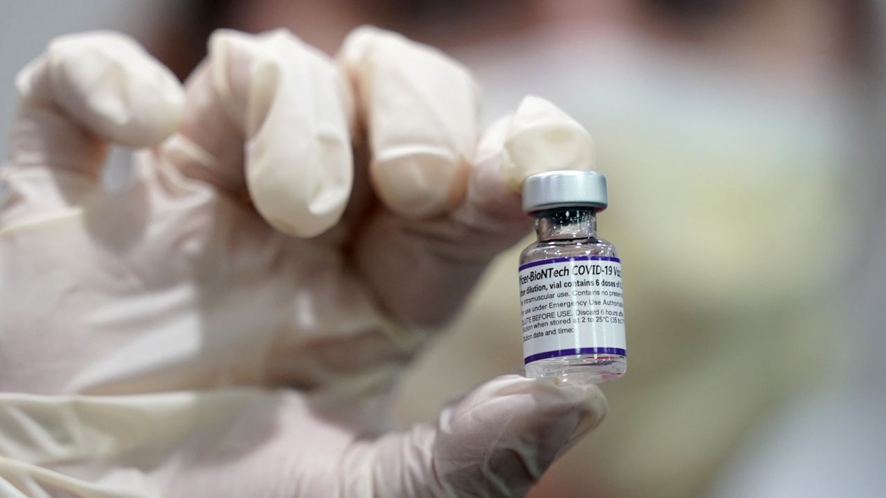 FILE - A healthcare worker holds a vial of the Pfizer COVID-19 vaccine at Jackson Memorial Hospital in Miami, in this Tuesday, Oct. 5, 2021. (AP Photo/Lynne Sladky, File)