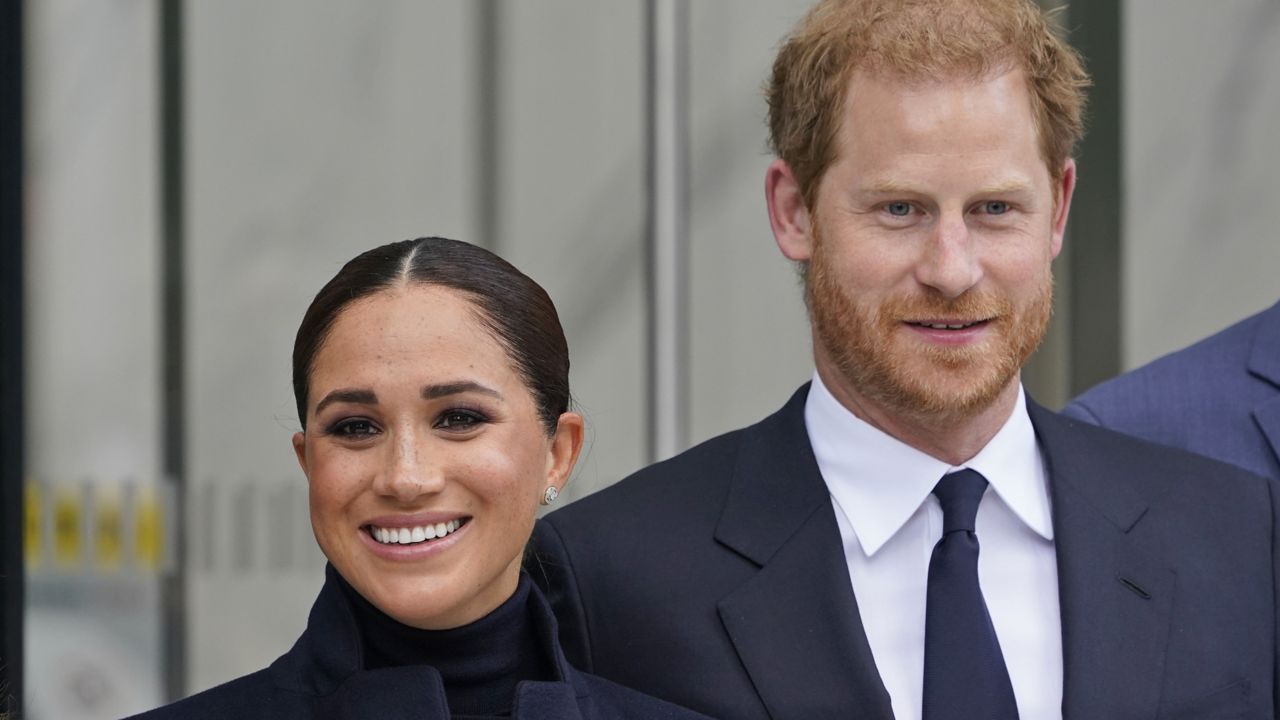 Meghan Markle and Prince Harry pose for pictures after visiting the observatory in One World Trade in New York, Thursday, Sept. 23, 2021. (AP Photo/Seth Wenig)