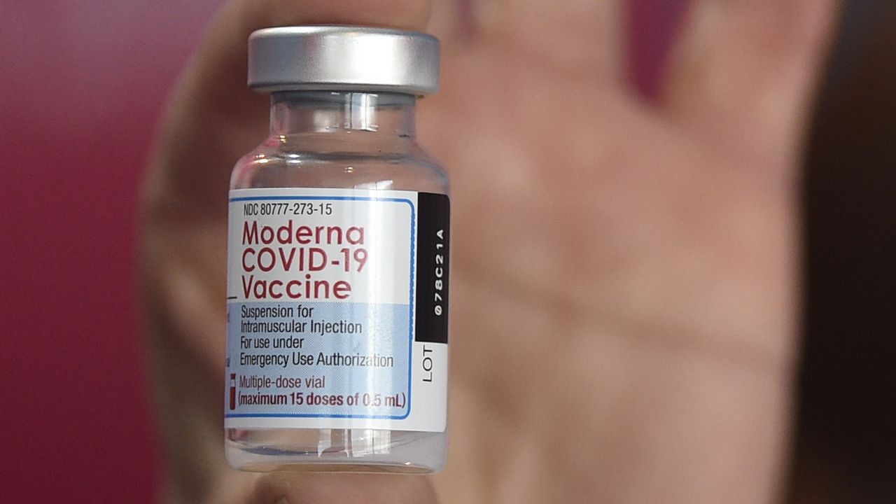 FILE: A health worker shows a vial of the Moderna vaccine for COVID-19. (AP Photo/Gustavo Garello)