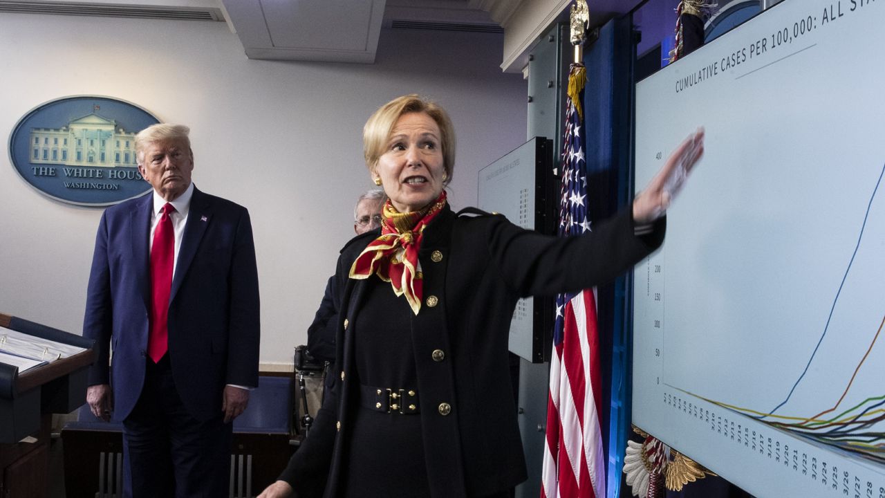 Dr. Deborah Birx gestures to a chart as President Donald Trump listens as they speak about the coronavirus on Tuesday, March 31, 2020, in Washington. (AP Photo/Alex Brandon)