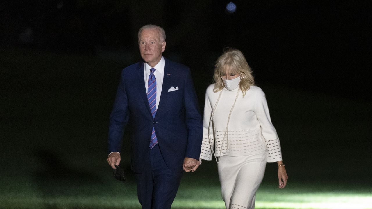 President Joe Biden and first lady Jill Biden walk on the South Lawn of the White House after stepping off Marine One, Thursday, Oct. 21, 2021, in Washington. (AP Photo/Patrick Semansky)