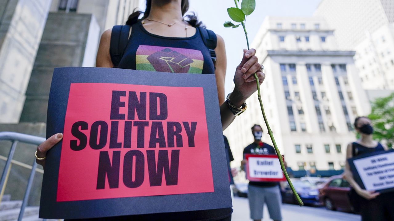 FILE: Demonstrators hold signs outside Manhattan criminal court during a march and rally to demand the end of solitary confinement in New York, Monday, June 7, 2021. (AP Photo/Mary Altaffer)