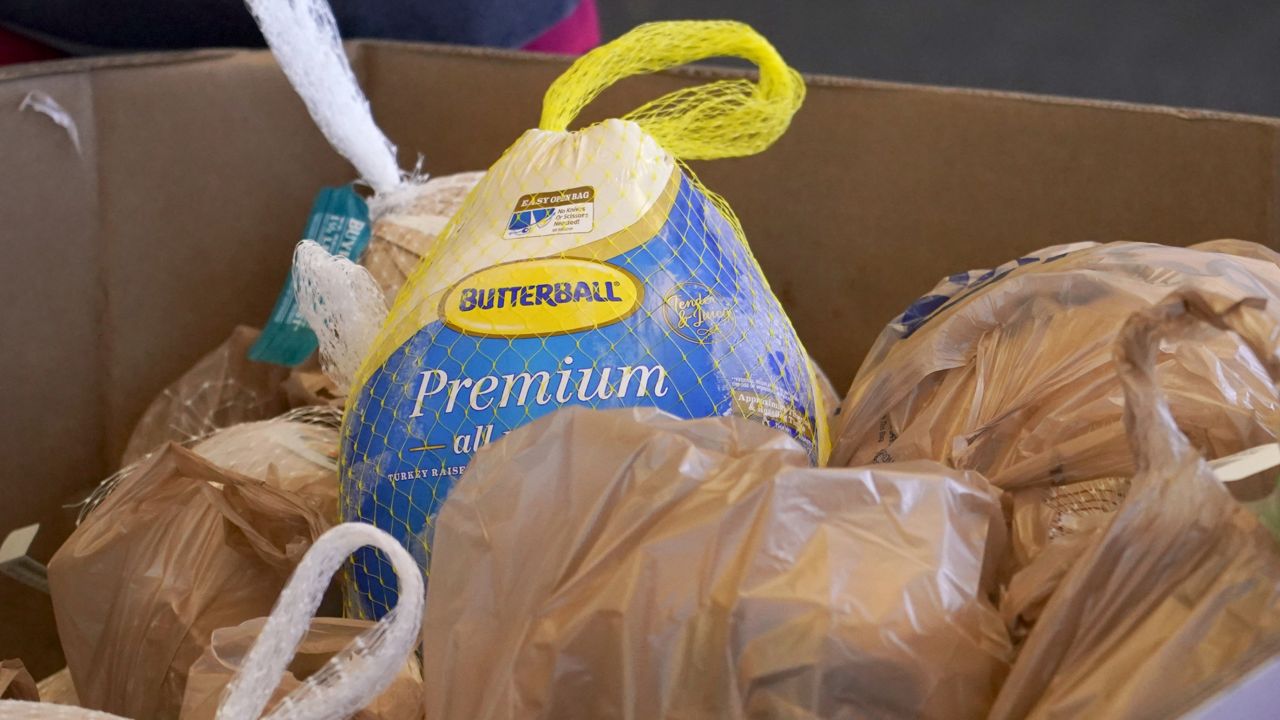 FILE: Forty five donated frozen turkeys await collection at this north Jackson, Miss., Kroger grocery store, Thursday, Nov. 19, 2020. (AP Photo/Rogelio V. Solis)