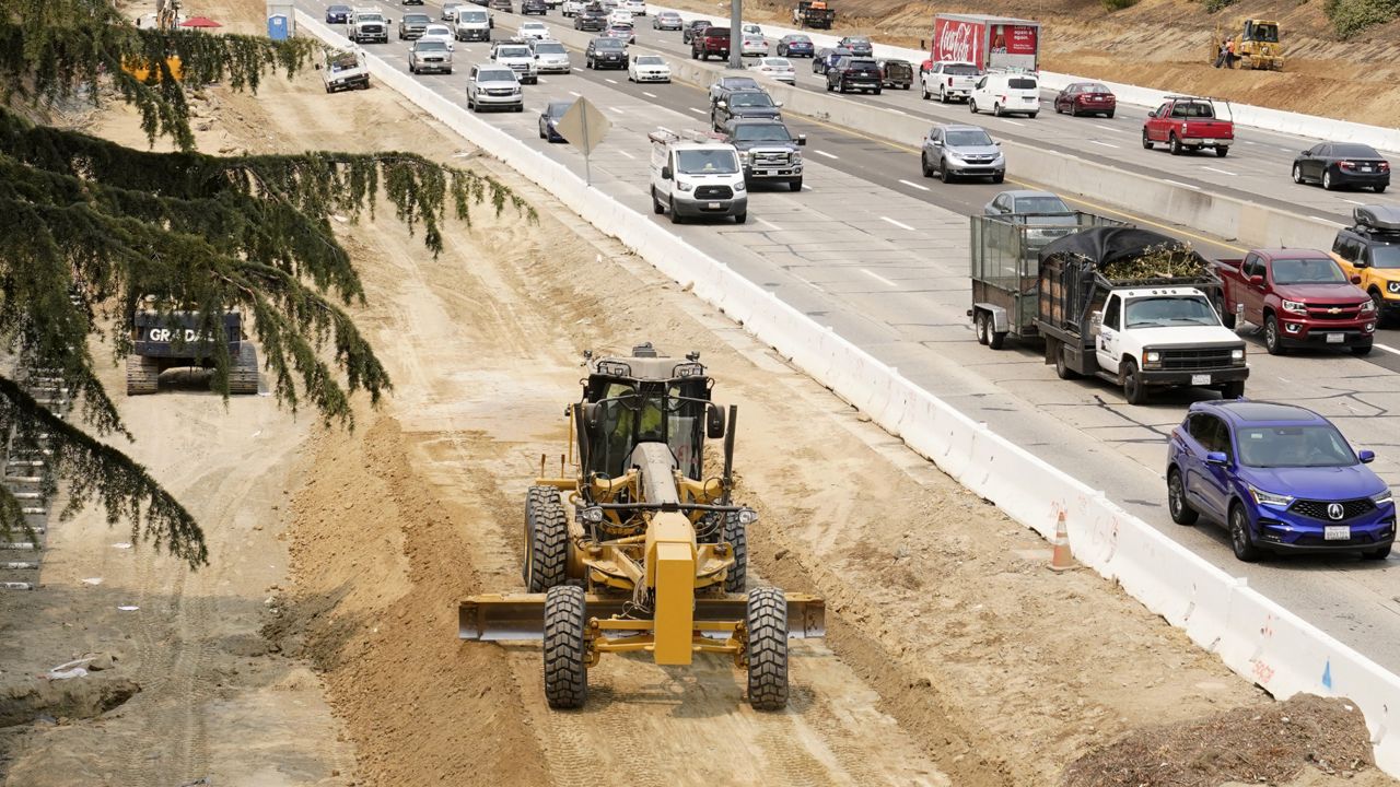 Traffic flows past construction work on eastbound Highway 50 in Sacramento, Calif., Thursday, Aug. 12, 2021. (AP Photo/Rich Pedroncelli)