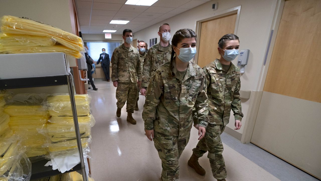 Members of the Maine National Guard arrive for orientation an empty wing at Central Maine Medical Center, Thursday, Dec. 16, 2021, in Lewiston, Maine. The Guard will work as nursing assistants, helping to open a swing bed unit of the hospital that has been closed due to a nursing shortage. (AP Photo/Robert F. Bukaty)