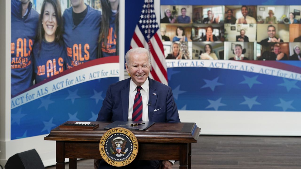 President Joe Biden smiles after signing the "Accelerating Access to Critical Therapies for ALS Act" into law during a ceremony in the South Court Auditorium on the White House campus in Washington, Thursday, Dec. 23, 2021. (AP Photo/Patrick Semansky)