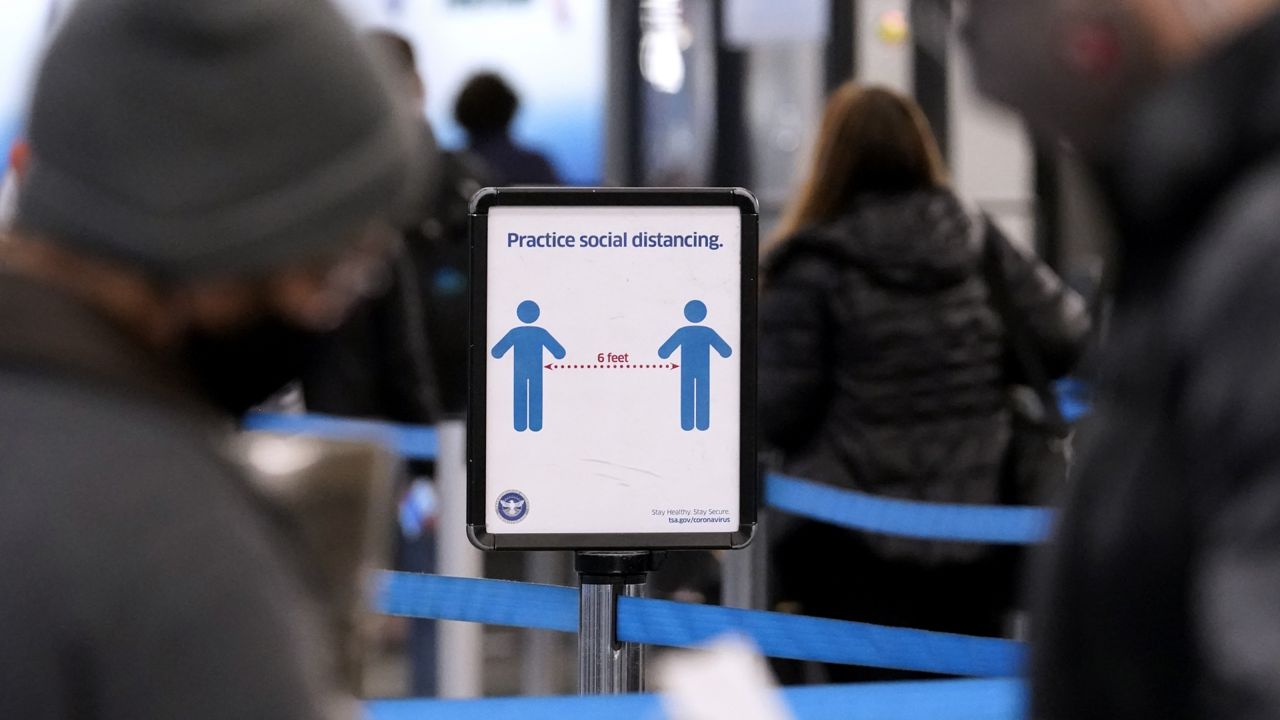 FILE: An information sign about social distancing is displayed at O'Hare International Airport in Chicago, Tuesday, Dec. 28, 2021. (AP Photo/Nam Y. Huh)