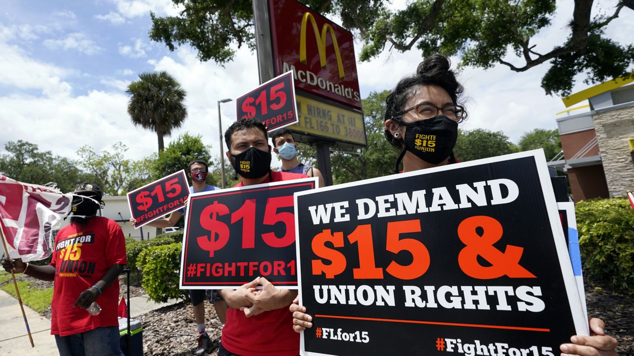 FILE - Workers and family members take part in a 15-city walkout to demand $15hr wages Wednesday, May 19, 2021. (AP Photo/John Raoux, File)