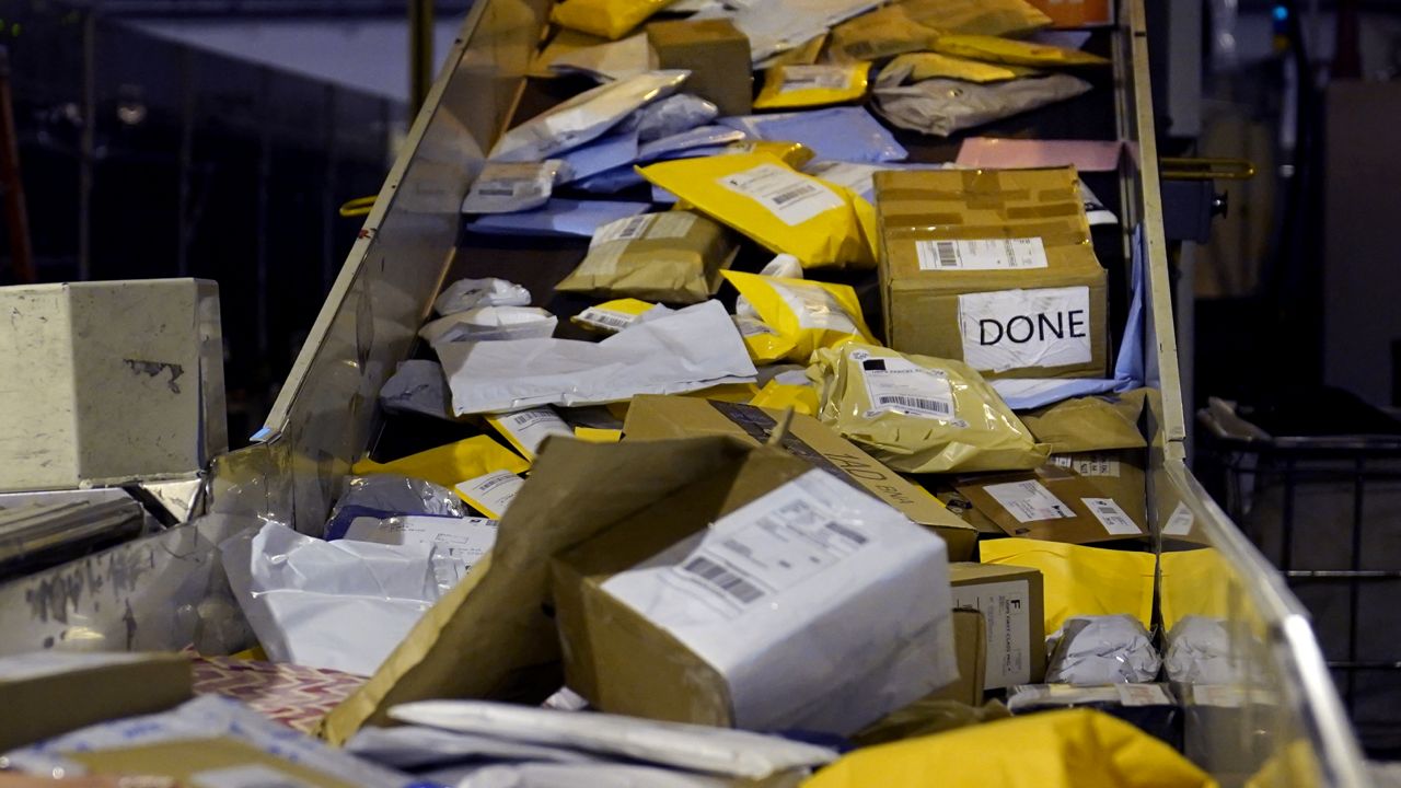 FILE: Parcels jam a conveyor belt at the United States Postal Service sorting and processing facility, Thursday, Nov. 18, 2021. (AP Photo/Charles Krupa)