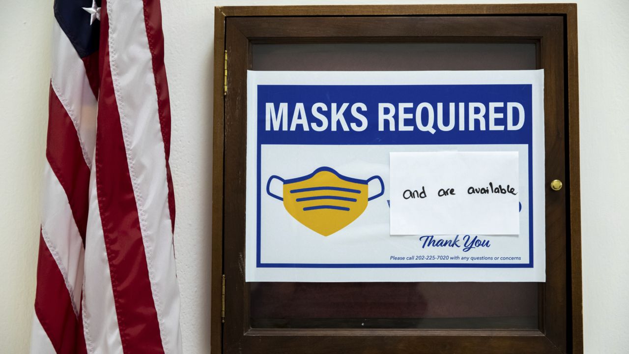 FILE: A sign requiring the use of masks on Capitol Hill in Washington, Wednesday, Dec. 1, 2021. (AP Photo/Amanda Andrade-Rhoades)