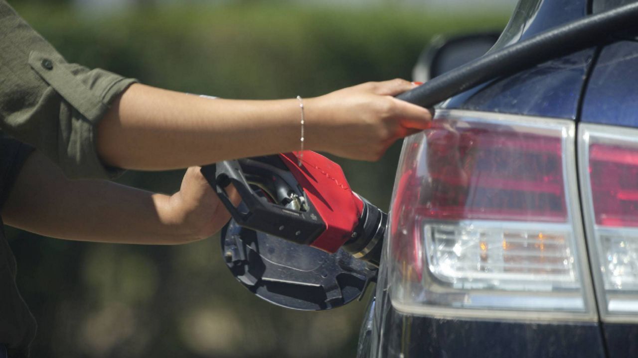 A motorist fills up a vehicle at a Costco warehouse Monday, Aug. 15, 2022, in Sheridan, Colo. (AP Photo/David Zalubowski)