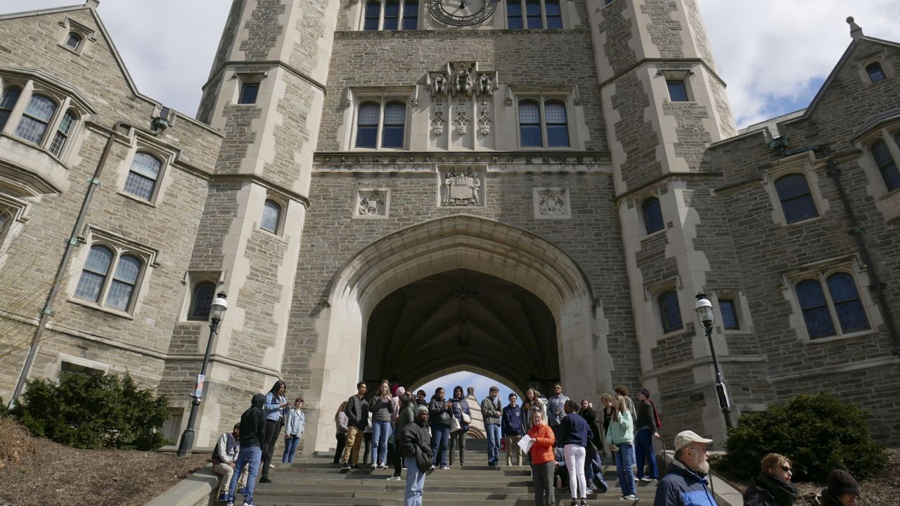 FILE - In this April 5, 2018, file photo, people walk through the Princeton University campus in Princeton, N.J. The Trump administration has opened an investigation into racial bias at Princeton University, Wednesday, Sept. 16, 2020, saying that the school's recent acknowledgment of racism on campus amounts to a "shocking" and "serious" admission of discrimination. (AP Photo/Seth Wenig, File)