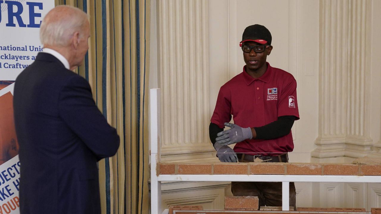 President Joe Biden listens to Jamaar Evans, a bricklayer apprentice, as he views workforce training demonstration in the State Dining Room of the White House, Wednesday, Nov. 2, 2022, in Washington. (AP Photo/Evan Vucci)