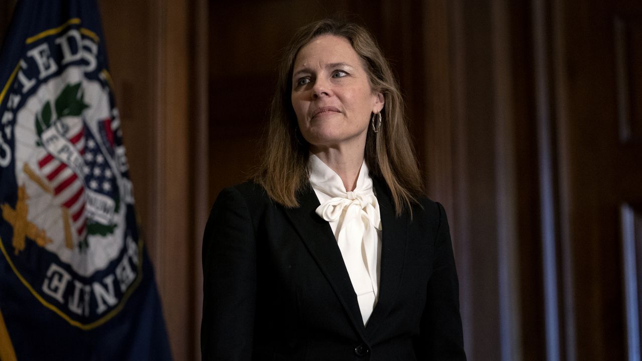 Judge Amy Coney Barrett, President Donald Trumps nominee for the U.S. Supreme Court, meets with Sen. John Hoeven, R-N.D., on Capitol Hill in Washington, Thursday, Oct. 1, 2020. (Stefani Reynolds/Pool via AP)